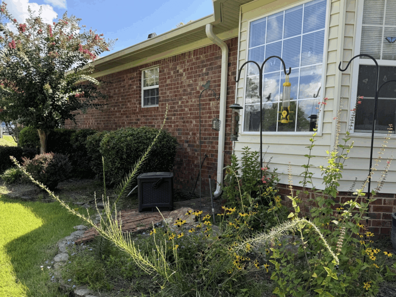 Garden after planting where yellow and green plants dominate.