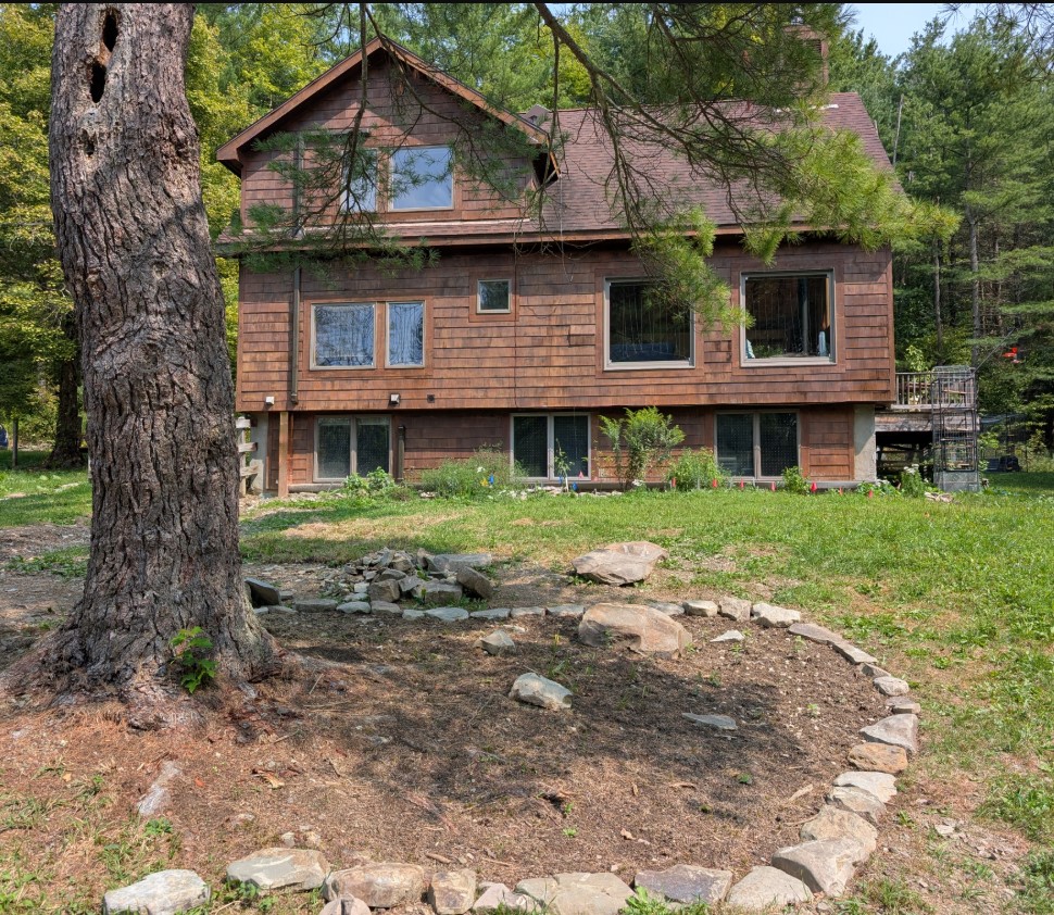 a house behind a flowerbed