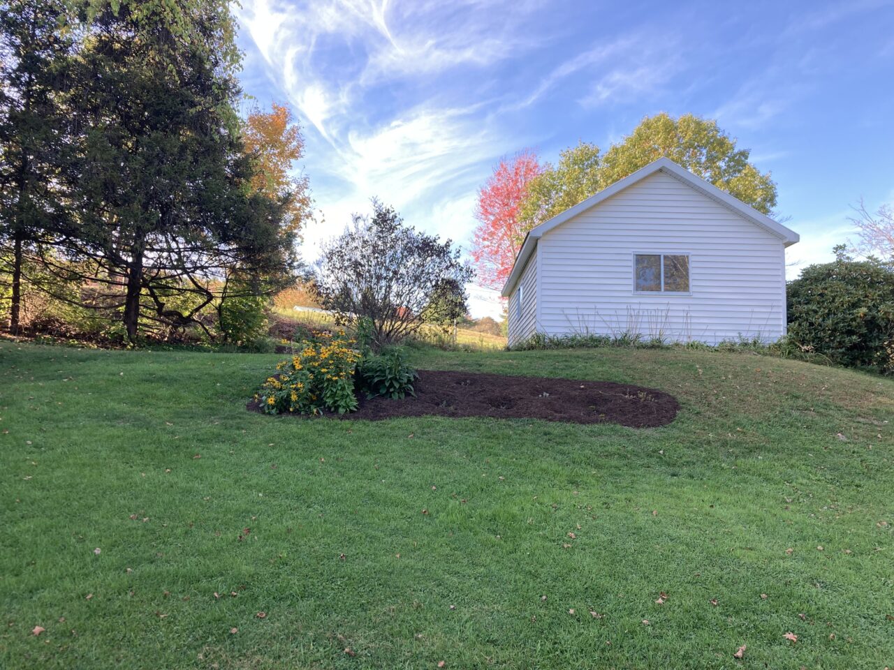 a flower bed on a grassy slope