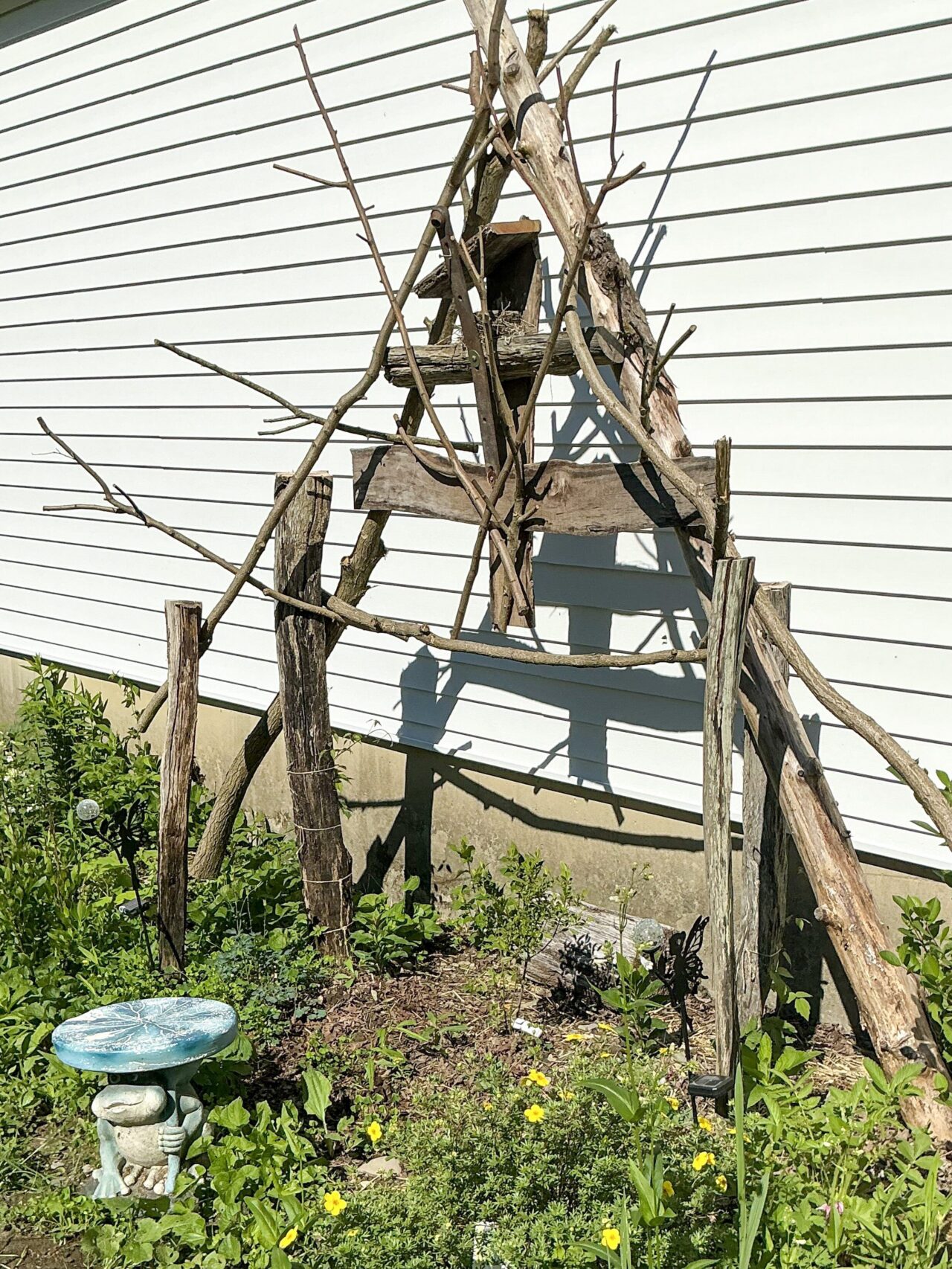 a wooden trellis against a white wall